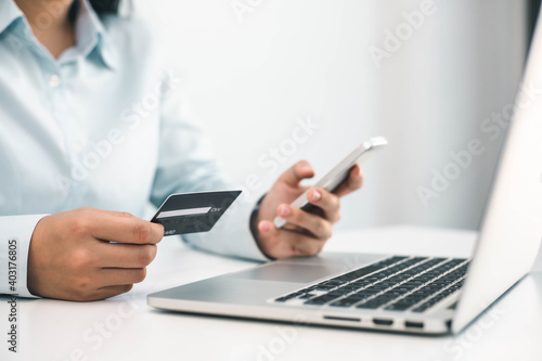 Business people hold credit cards and use smart Fone in online shopping Business idea.