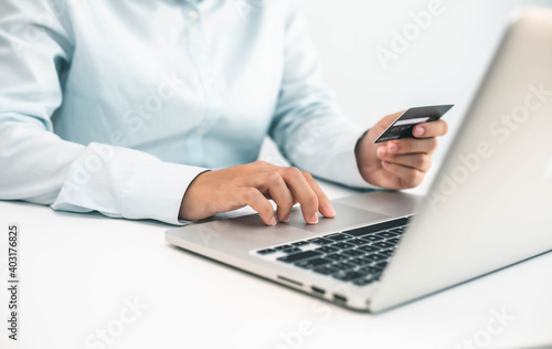 business hands holding credit card and using laptop computer for online shopping  Online payment and shopping
