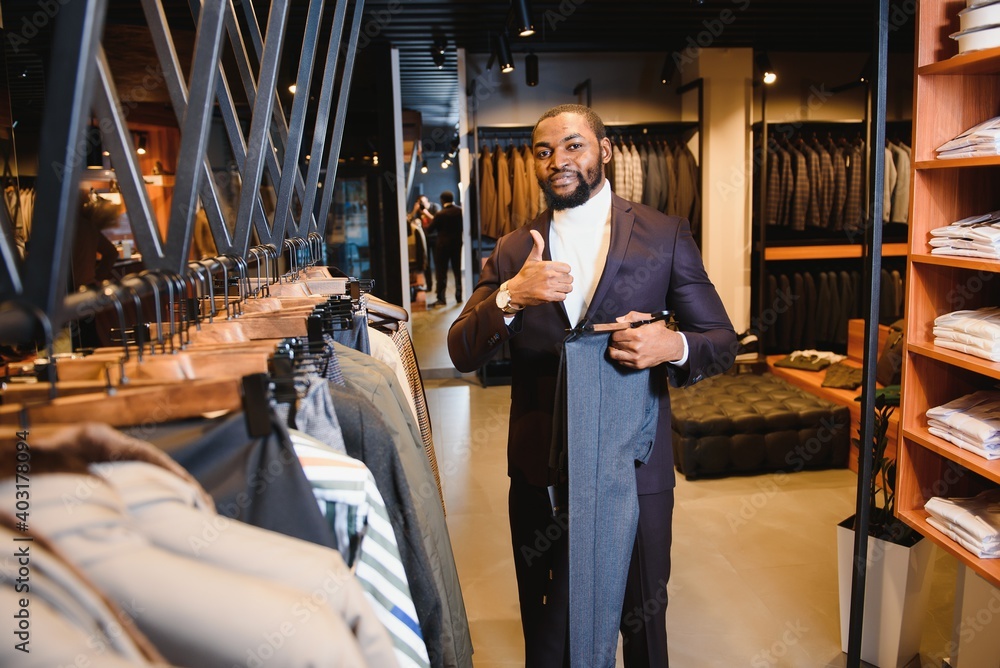 African American man, clothing store, chooses clothes African American man, clothing store, chooses clothes