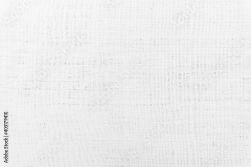 White fabric jute hessian sackcloth canvas woven gauze texture pattern in light white color blank. Natural linen and cotton cloth texture as clean background empty for decoration.
