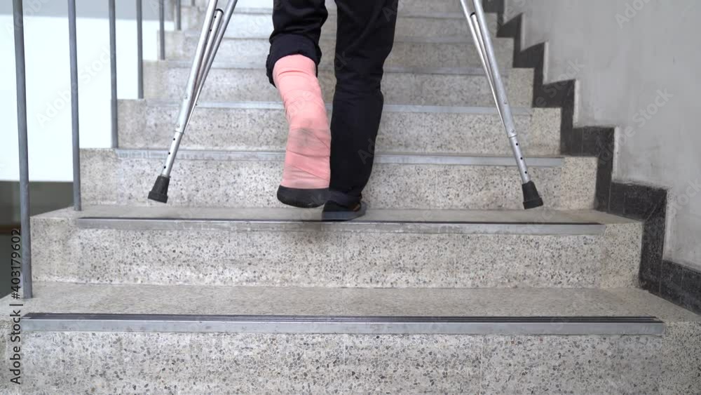 A young man with a broken leg used crutches to walk up and down the