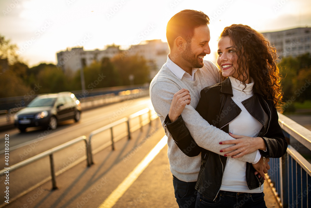 Happy young couple embracing laughing on date Happy young couple embracing laughing on date