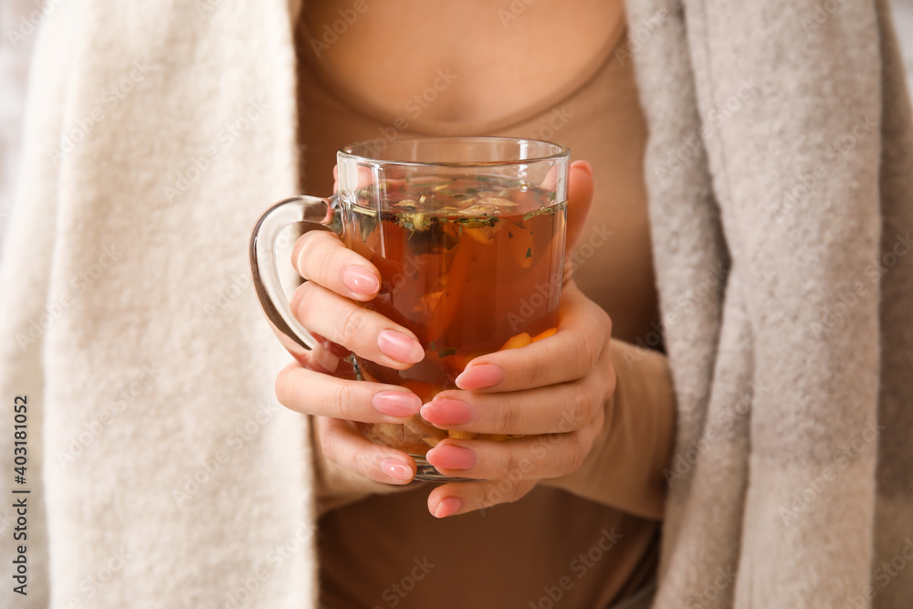 Woman holding cup of hot ginger tea, closeup Woman holding cup of hot ginger tea, closeup