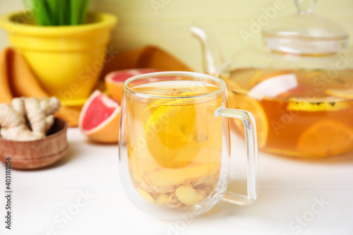 Cup of healthy tea with lemon and ginger on table