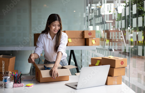 Starting small businesses SME owners female entrepreneurs check online orders to prepare to pack the boxes, sell to customers, sme business ideas online.