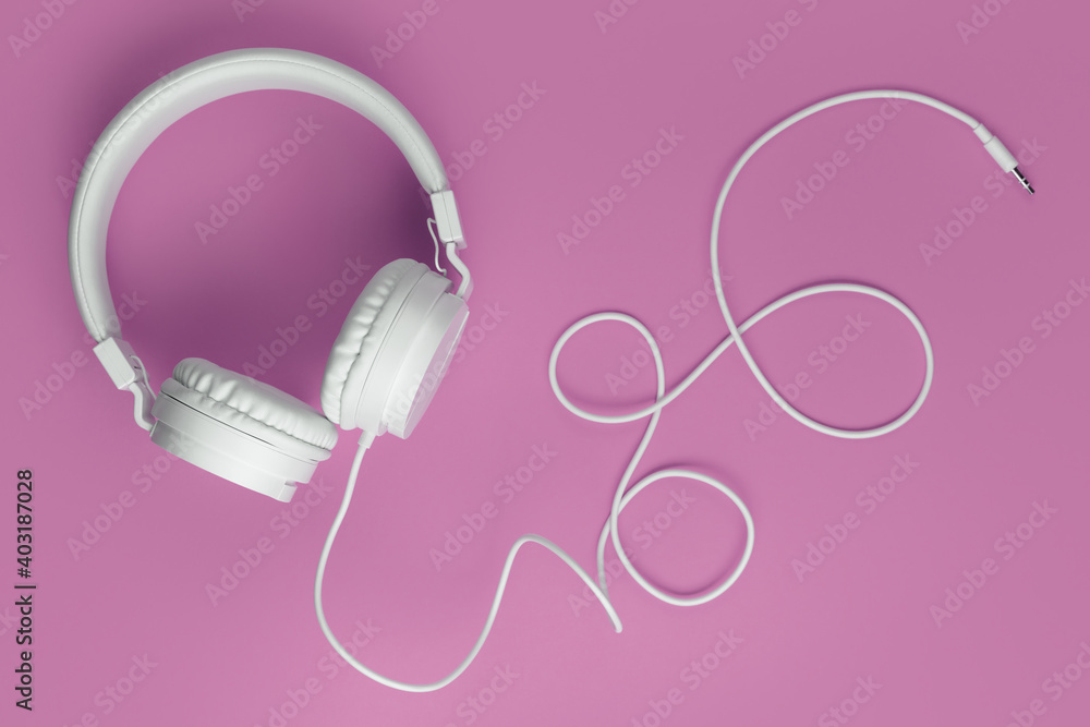 Cool white headphone on pink background. Music concept. Cool white headphone on pink background. Music concept.