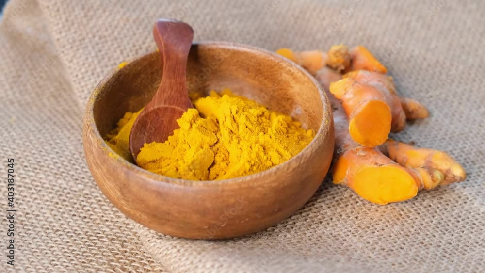 Turmeric Powder and roots, curcuma longa, kurkuma. panning turmeric on black background . top view. close up view. Slow motion video. stock footage. Turmeric Powder and roots, curcuma longa, kurkuma. panning turmeric on black background . top view. close up view. Slow motion video. stock footage.