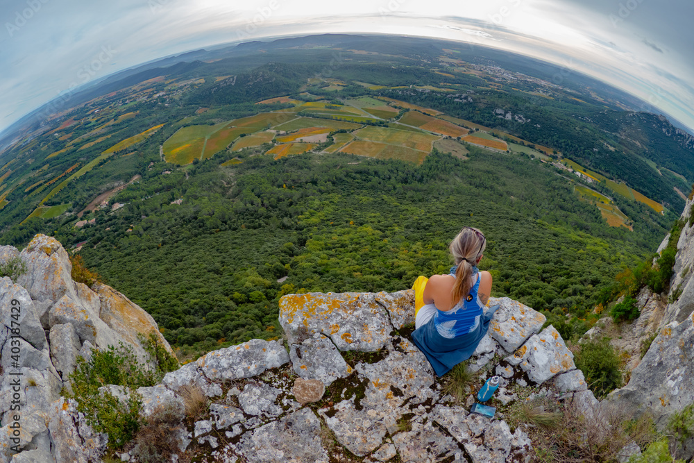 Naklejka premium Female hiker hiking the cliffs of the Masif Central in southern France