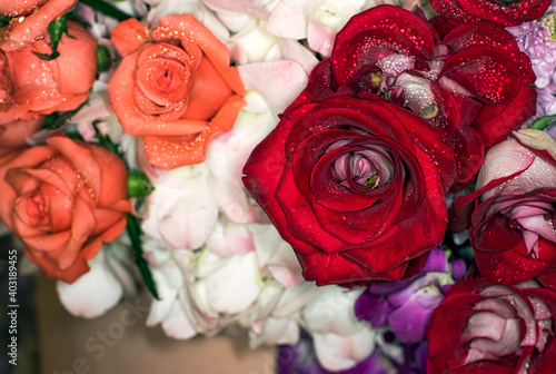 Close-up of a mixed bouquet of roses summer flowers background.