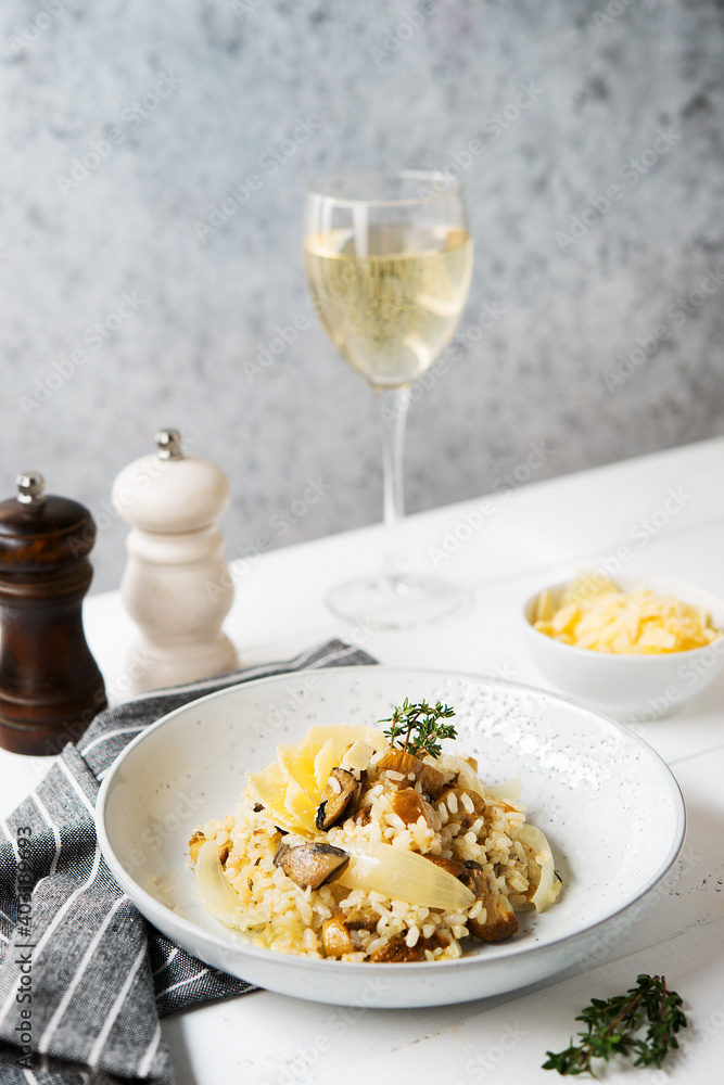 Risotto with porcini mushrooms and parmesan on a light background Risotto with porcini mushrooms and parmesan on a light background