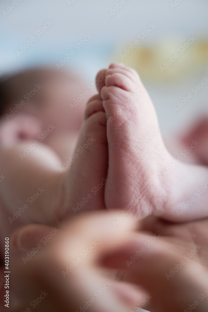 Small feet of a newborn close up. The first days of a baby's life. Small feet of a newborn close up. The first days of a baby's life.