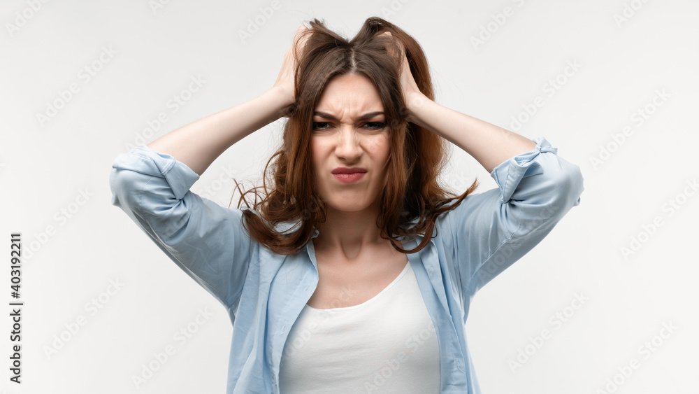 Portrait of woman in panic shouting and grabbing her head in fear or frustration. Stress and mental health Portrait of woman in panic shouting and grabbing her head in fear or frustration. Stress and mental health