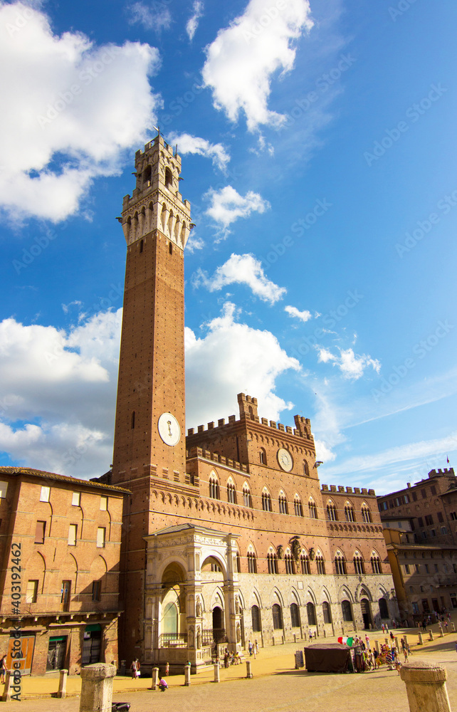 Palazzo Pubblico and Mangia Tower (Torre del Mangia) un Campo Square (Piazza del Campo) in Siena, Tuscany region, Italy. The historic centre declared by UNESCO a World Heritage Site. Wide angle photo