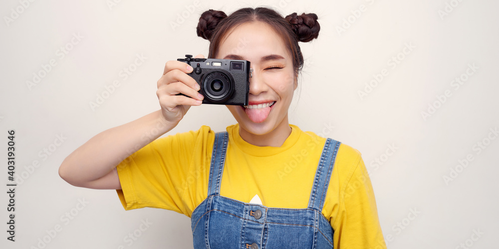 hipster photographer fashion stylish woman dancing and making photo using retro camera.