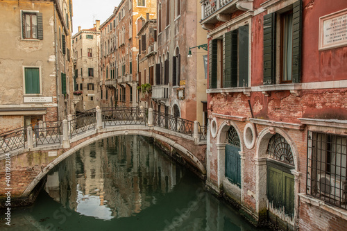 Old bridge in Venice Italy over a canal and surrounded by old buildings.  © Chris