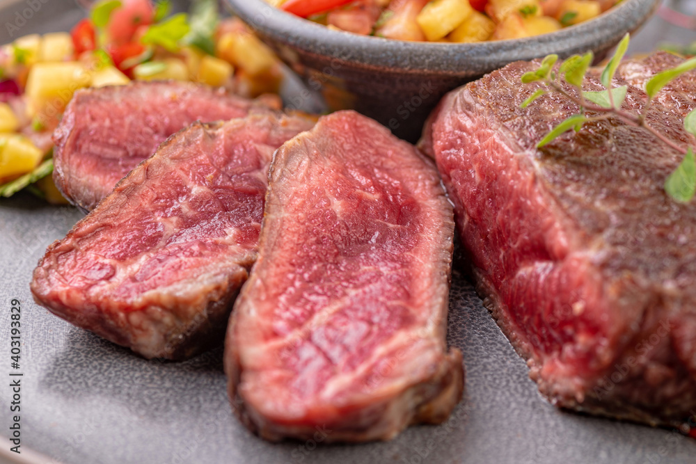 Fried beef steak with peach fruit salsa, tomato and chili. Fried beef steak with peach fruit salsa, tomato and chili.