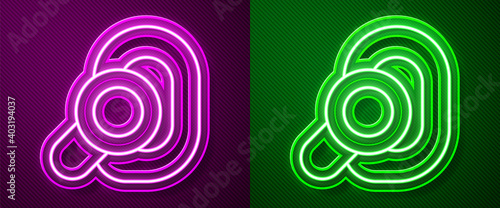 Glowing neon line Hearing aid icon isolated on purple and green background. Hearing and ear. Vector.