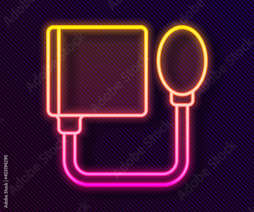 Glowing neon line Blood pressure icon isolated on black background. Vector.