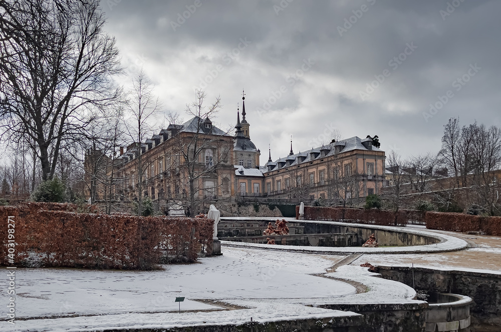 Beautiful snowy public gardens and exterior of the famous Baroque Palace,called little Versailles,in the Granja of San Ildefonso,Segovia,Castilla y Leon,Spain