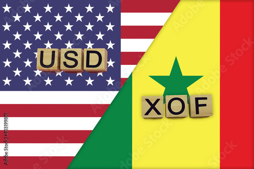 USA and Senegal currencies codes on national flags background photo