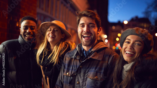Portrait Of Group Of Friends In City Outdoors On Night Out Together