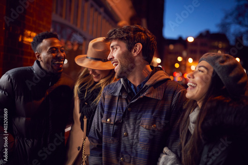 Group Of Friends In City Outdoors On Night Out Together