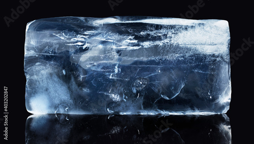 A rectangular block of ice isolated on black background with clipping path. photo