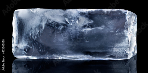 Rectangular block of ice isolated on a black background with clipping path. photo