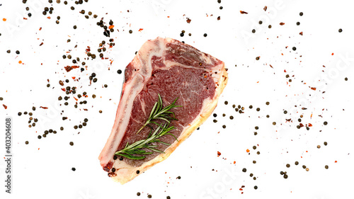 Steak with rosemary and pepper on a white background. photo