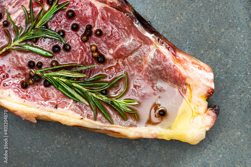Bild auf Leinwand Steak with rosemary and pepper on a black background.