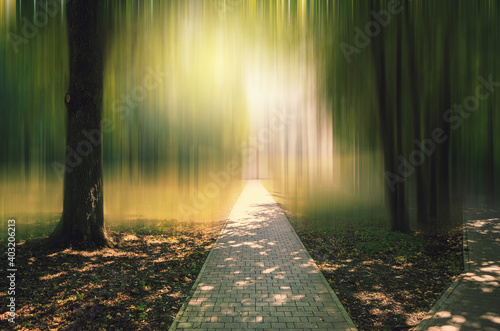 Abstract blurred summer landscape with stone road in park