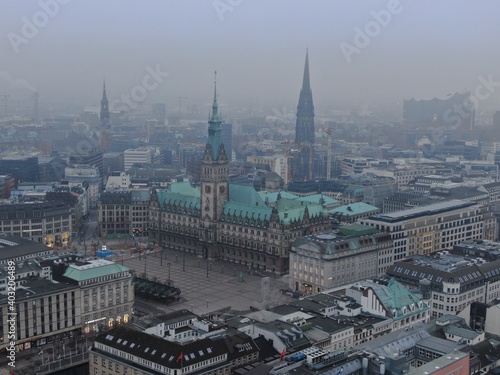 Aerial drone shot of the Townhall in Hamburg, Germany with bad weather in a misty atmosphere