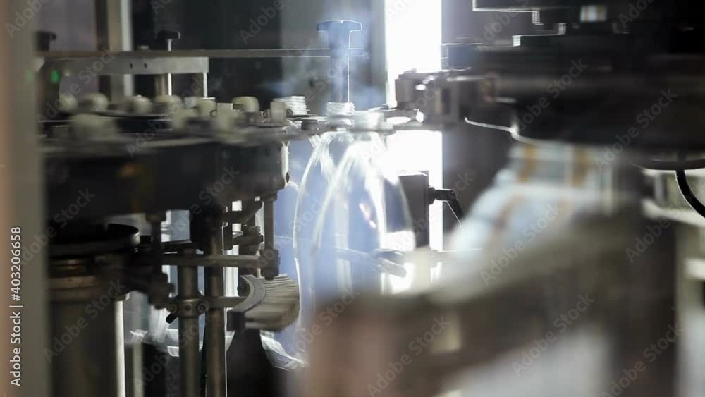production of mineral water. A line of bottled sparkling water in bottles. Mineral water production of mineral water. A line of bottled sparkling water in bottles. Mineral water