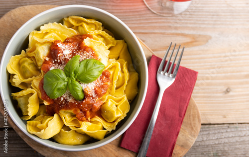 Fresh made delicious italian tortellini with arrabbiata sauce and cheese. top view. photo