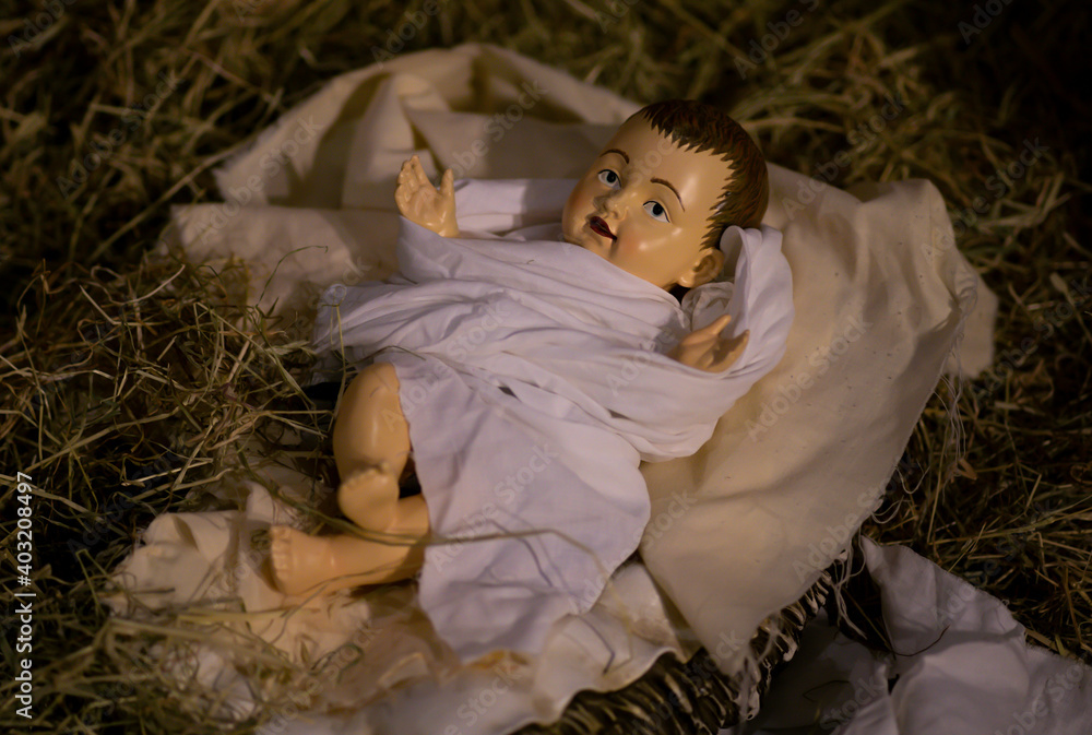 Baby Jesus Figurine Lying in a Manger with Swaddling White Clothes and