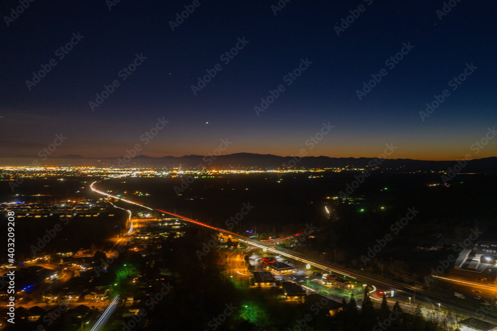 Dark small town at night with mountains as background