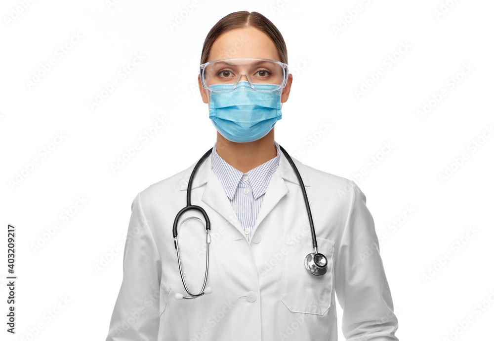 health, medicine and pandemic concept - young female doctor with stethoscope wearing goggles and face protective medical mask for protection from virus disease health, medicine and pandemic concept - young female doctor with stethoscope wearing goggles and face protective medical mask for protection from virus disease