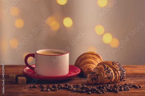 cup of coffee, croissants, on a wooden surface