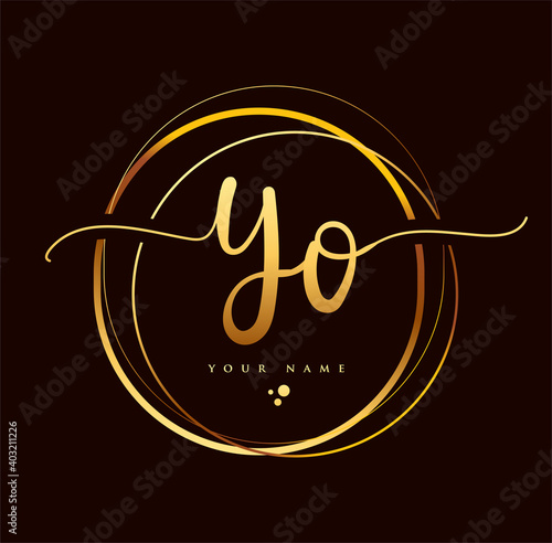 YO Initial handwriting logo golden color. Hand lettering Initials logo branding, Feminine and luxury logo design isolated on black background.