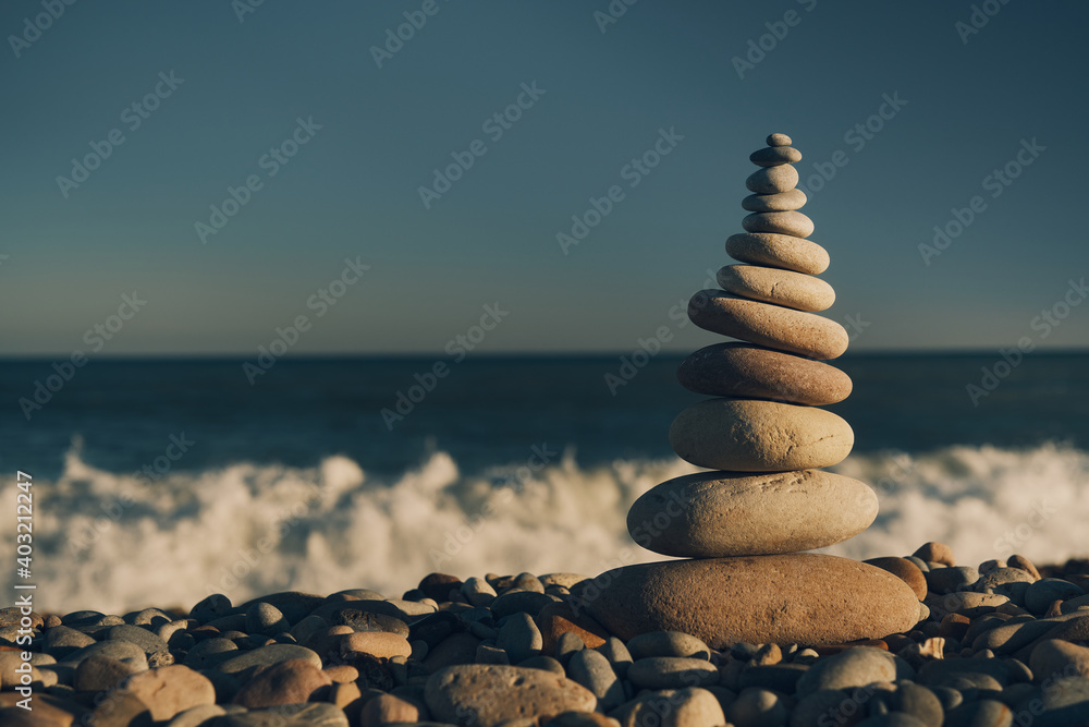 Fototapeta premium pyramid of stones with sea view