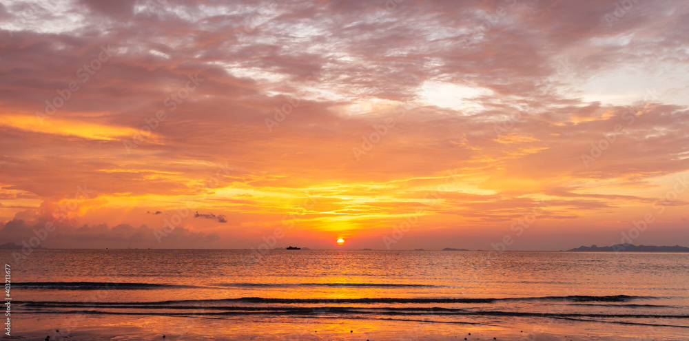 Beautiful tropical golden beach sunset with colourful sea sky