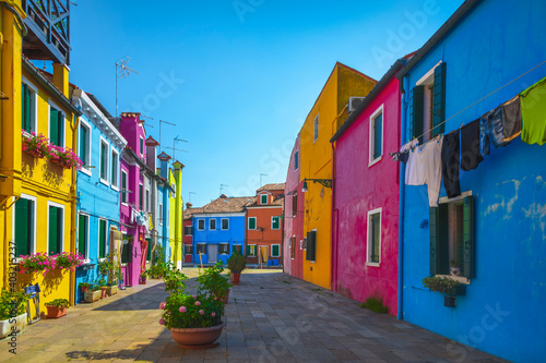 Burano island canal, colorful houses and boats in the Venice lagoon. Italy © stevanzz