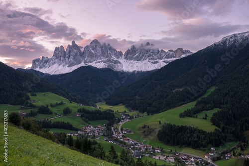 Sunrise over the small Italian mountain town of St. Magdalena in Val di Funes