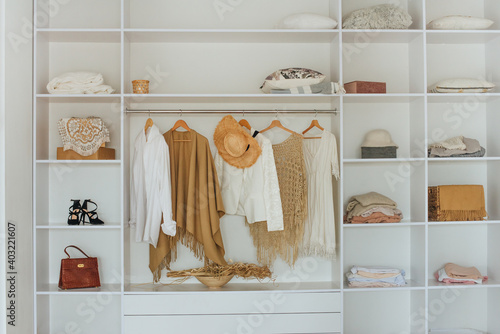 Принти на полотні Open white built-in wardrobe with female clothes