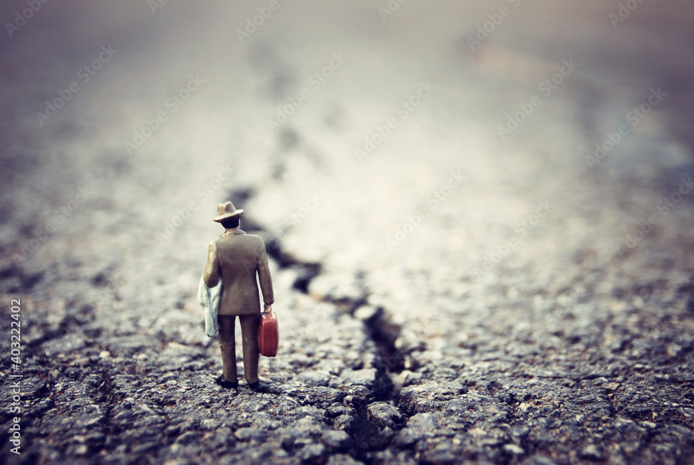 Fototapeta premium Surreal image of mysterious man walking alone in urban environment