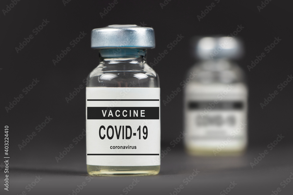 Covid-19 vaccine on a laboratory bench. to fight the coronavirus sars-cov-2 pandemic. Dark bacground Covid-19 vaccine on a laboratory bench. to fight the coronavirus sars-cov-2 pandemic. Dark bacground
