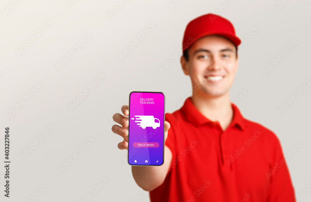 Courier man holding cellphone with delivery tracking app Courier man holding cellphone with delivery tracking app