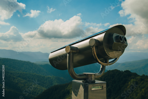 Coin Operator Binocular viewer Landscape with a beautiful cloudy sky and mountains ..