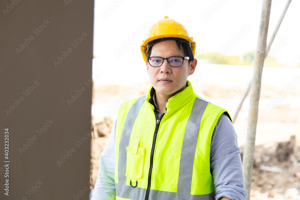 Attractive Asian engineer working on construction site. construction worker concept. Attractive Asian engineer working on construction site. construction worker concept.