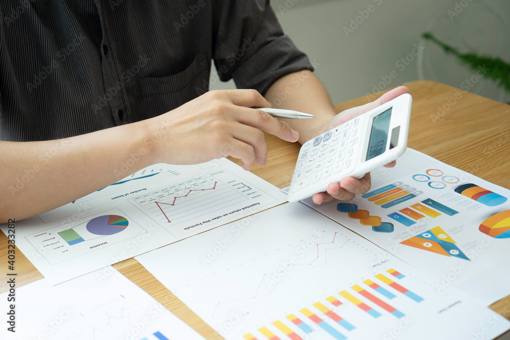 Asian male finance staff Is explaining the performance from the company's rapidly growing bar graph this year. To his boss On the desk at the office, Finance concept Asian male finance staff Is explaining the performance from the company's rapidly growing bar graph this year. To his boss On the desk at the office, Finance concept